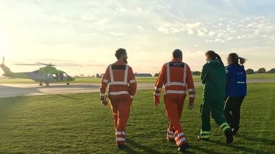 EMBRACE Air ambulance crew walk to helicopter