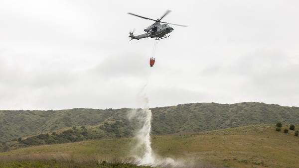 Helicopter carrying fire retardant