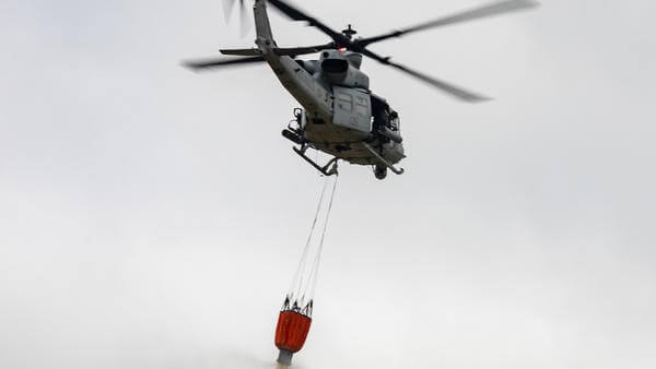 Helicopter carrying fire retardant