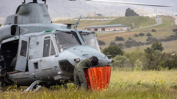 Helicopter pilot checking bag