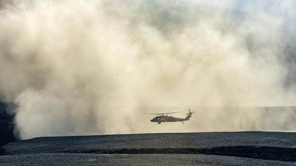 helicopter flying through dust