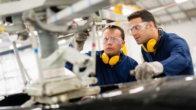 aircraft engineers working on helicopter rotor