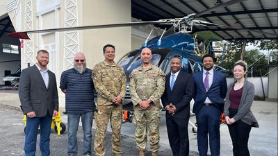 US and Guatemalan military representatives in front of Bell 429 helicopter