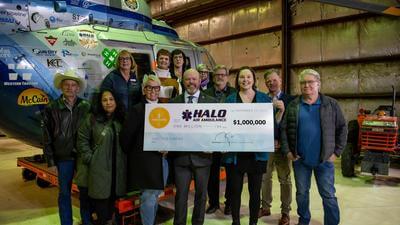 HALO Air Ambulance team with funding check