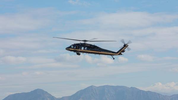 Helicopter above mountains