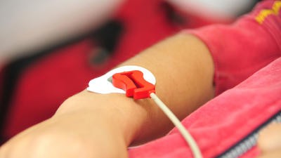 Young girl having blood transfusion