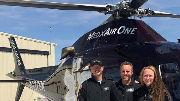 Photo of crew - left to right, Mike Sayler (pilot), Brent Tracy (paramedic), Becky Tissue (registered nurse).