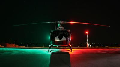 Helicopter on heli pad at night