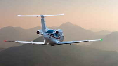 Small plane flying over mountains