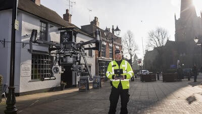 Man flying drone on high street