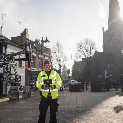 Man flying drone on high street