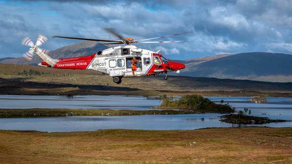 Helicopter with person about to hoist out