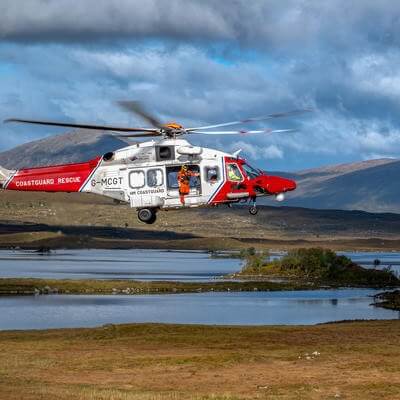 Helicopter with person about to hoist out