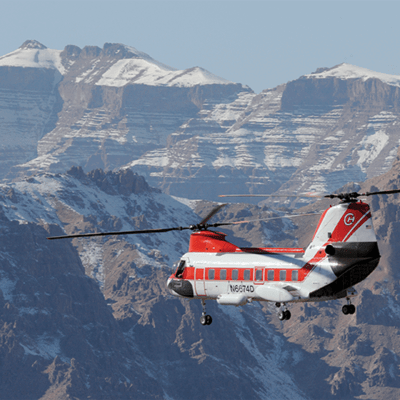 Helicopter flying above mountains