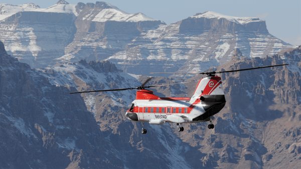 Helicopter flying above mountains