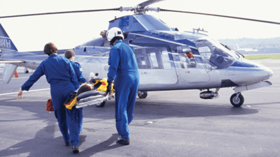 Paramedics carrying patient to helicopter 