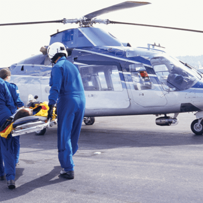 Paramedics carrying patient to helicopter 