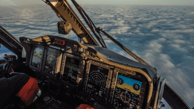 Helicopter flying above clouds