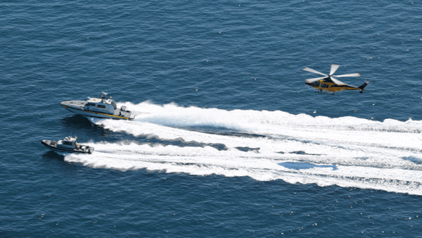 Helicopter and boats in the sea