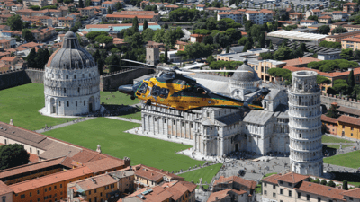 helicopter flying over leaning towers of Pisa