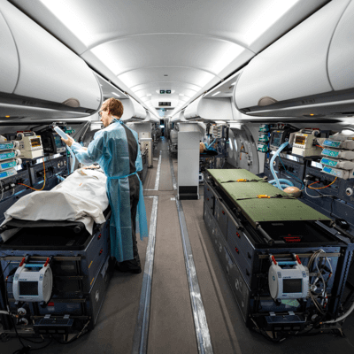 Paramedic treating patient on plane