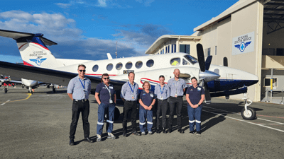 Crew standing in front of plane