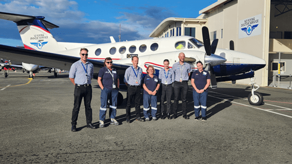 Crew standing in front of plane