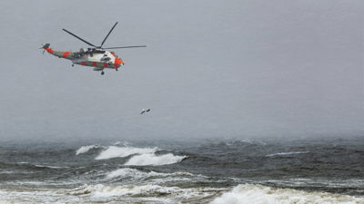 Rescue helicopter flying above sea