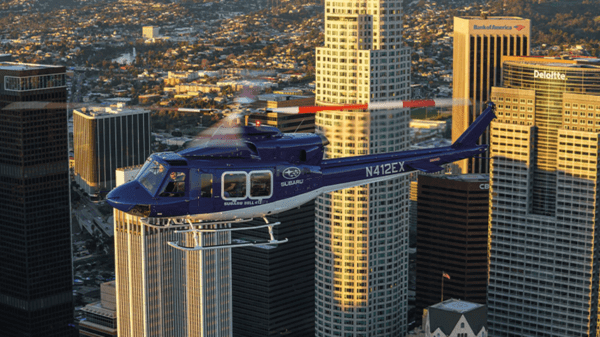 Helicopter flying next to sky scrapers